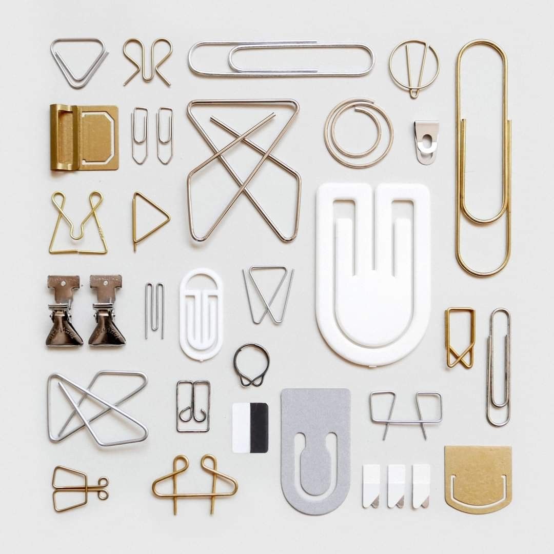 brown paper clips on white surface